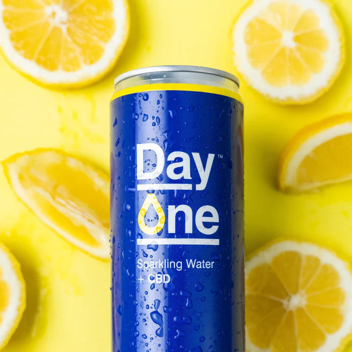 A can of lemon CBD Sparkling Water with lemon slices scattered
