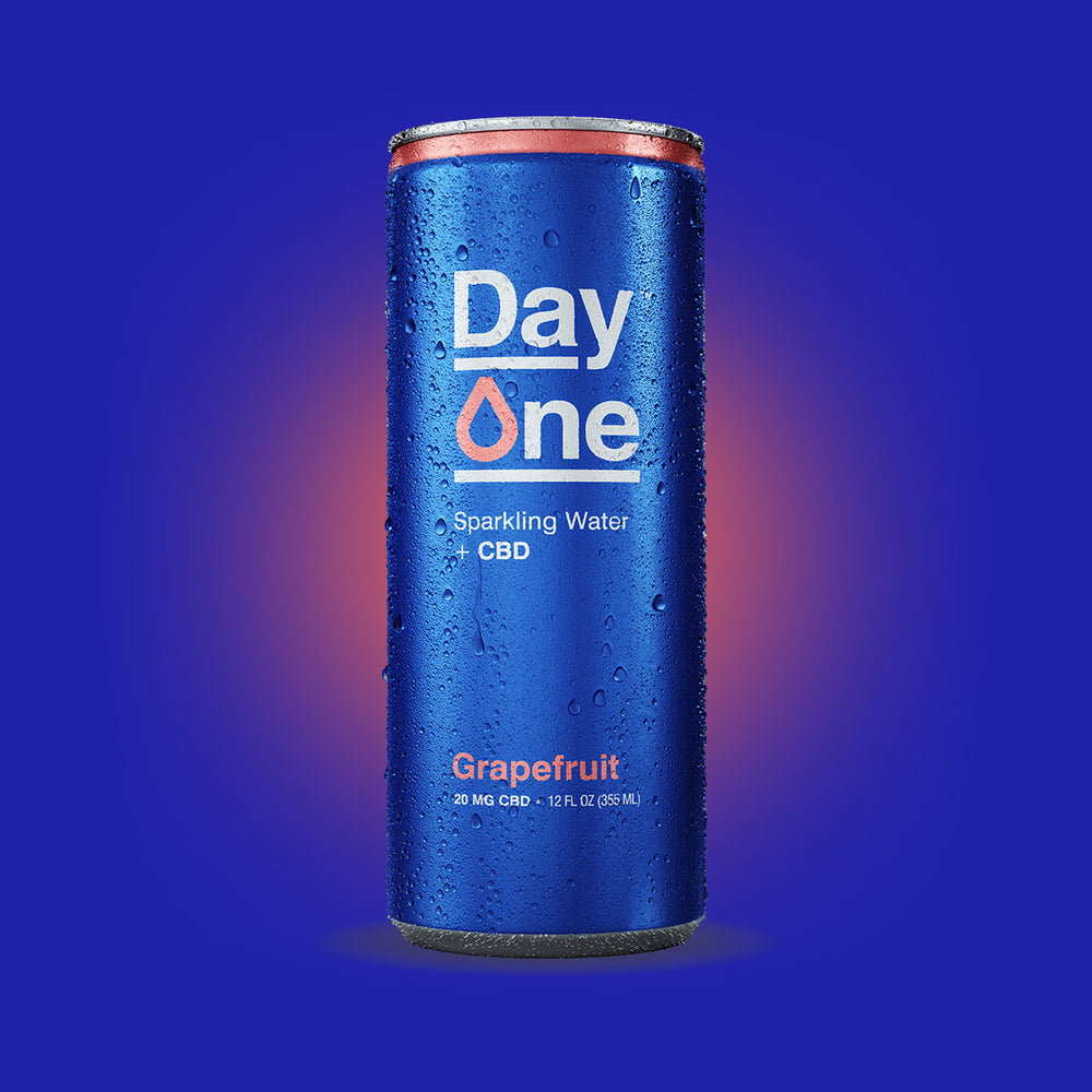 Cans of Day One Sparkling Water + CBD in grapefruit flavor