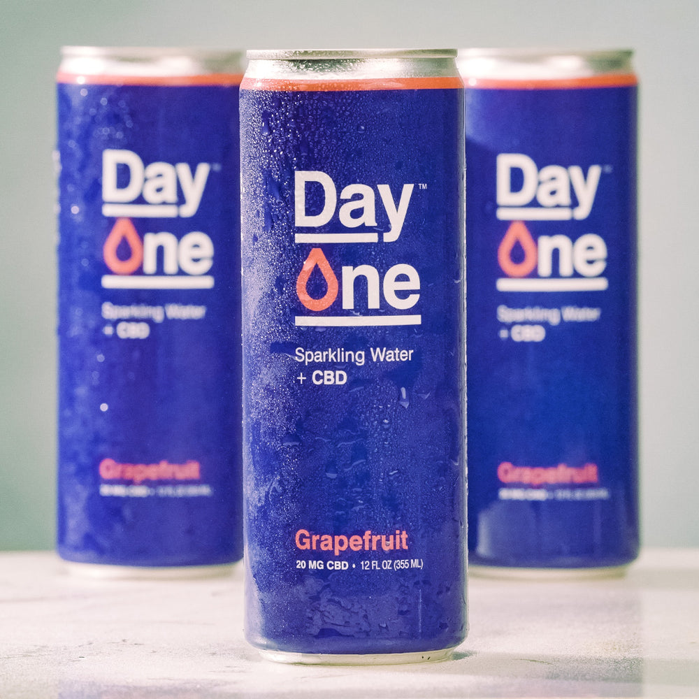 Three Day One cans of Sparkling Water + CBD in grapefruit flavor